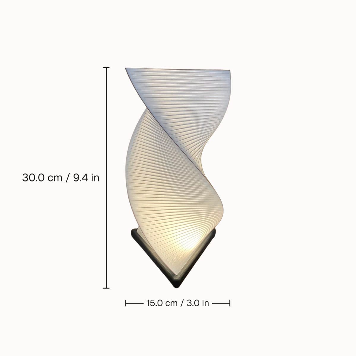 White twisted spiral table lamp on a white background, with height and width marked in centimetres and inches